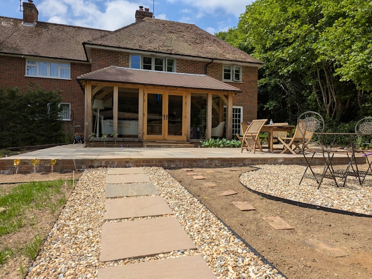 Softened garden corner with curved fence panels and climbers