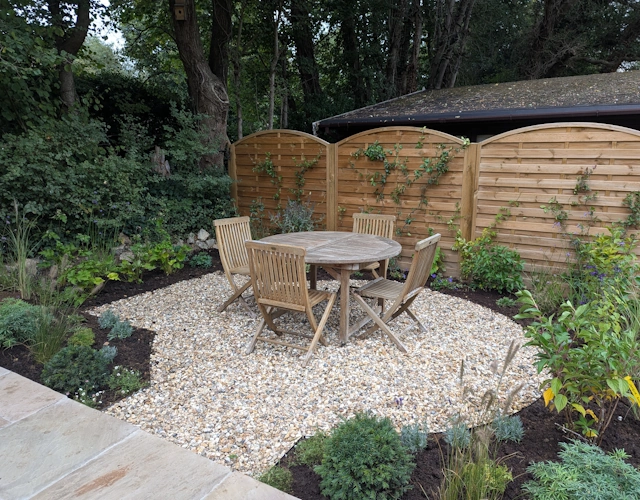 Cottage garden in Albury with sandstone terrace and classic English planting