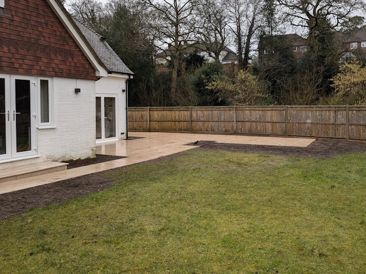 Extended terrace with distinct dining and lounging areas capturing sunlight throughout the day