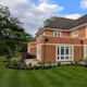 A contemporary family garden with pergola and generous borders