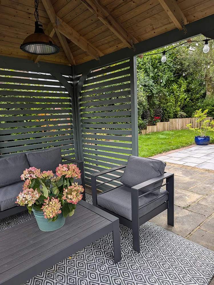 Inside the pergola with a view out to the back garden