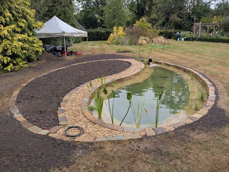 The completed wildlife pond with its natural yin-yang shape in the Farnham garden